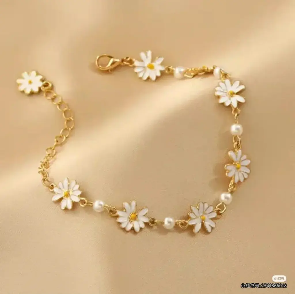 white flower on golden bracelet
